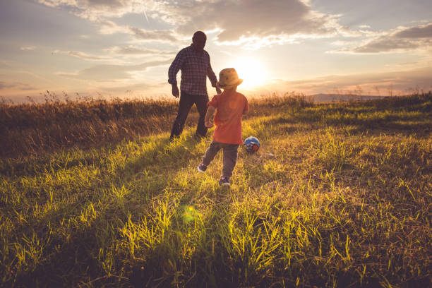 playing fútbol - ball horizontal outdoors childhood fotografías e imágenes de stock