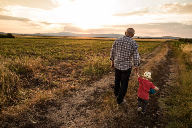 istock Cute grandfather and grandson going for a walk 803855492