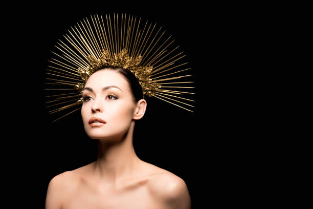 istock glamorous naked model posing in golden headpiece isolated on black 803866262