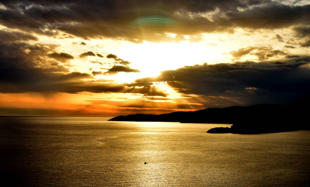 istock Sunset above the open sea, with cloudy sky 803872132