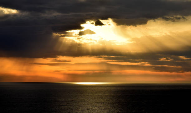 istock Sunset above the open sea, with cloudy sky 803872194