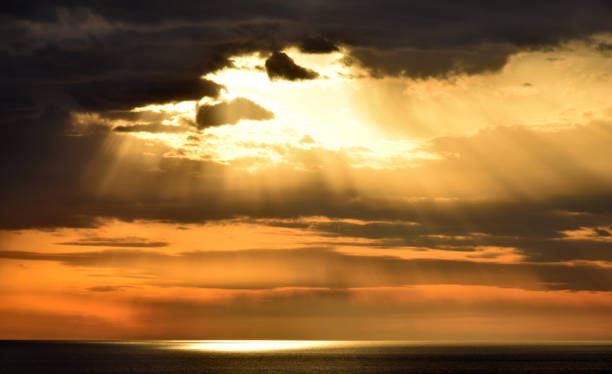 istock Sunset above the open sea, with cloudy sky 803872210