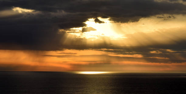 istock Sunset above the open sea, with cloudy sky 803872216