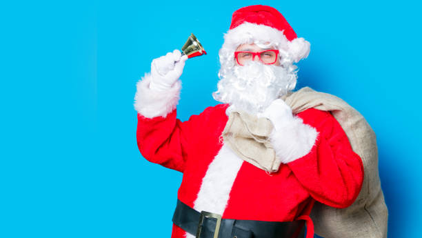 istock Funny Santa Claus have a fun with bell 803875174