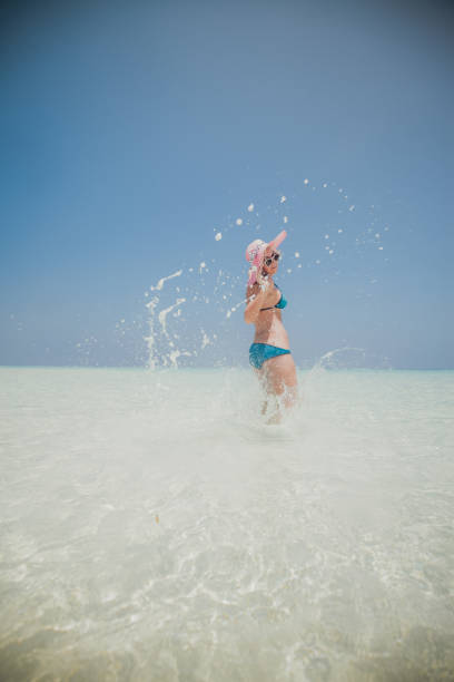 istock Woman jumping on the beach, Maldives 803875272