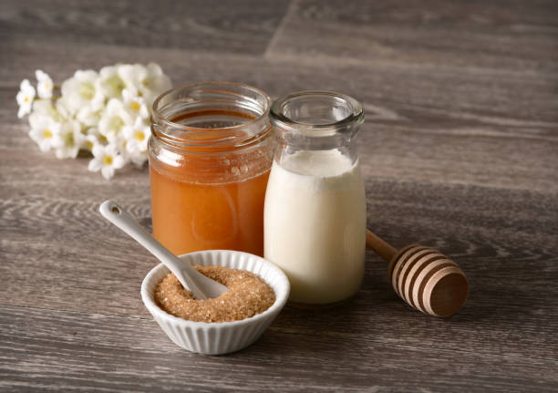 istock Milk and honey on wooden table 803878200
