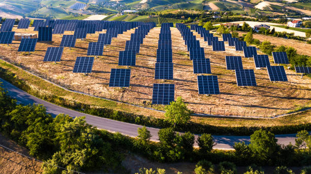 istock Fields of solar panels on the green hills in spring 803879676
