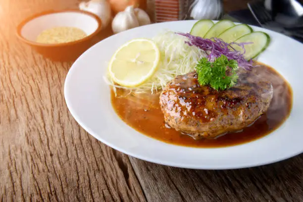 Photo of Japanese style hamberger or hamberg serve with gravy sauce.