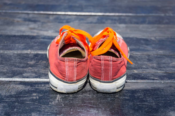 istock Orange shoes isolated on the wood background 803892548
