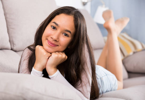 istock girl relaxation at home on comfortable sofa 803892556