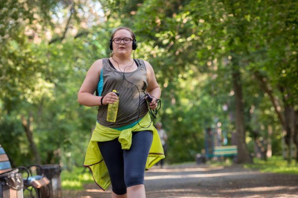 Overweight woman running. Weight loss concept. stock photo