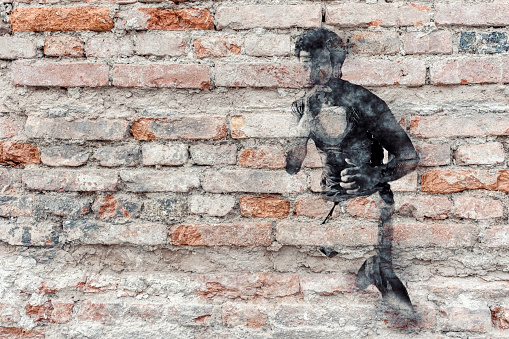 Boxer graffiti on old brick wall.