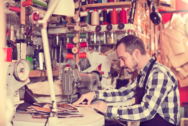 istock Professional man worker working on stitches for belt 803917126