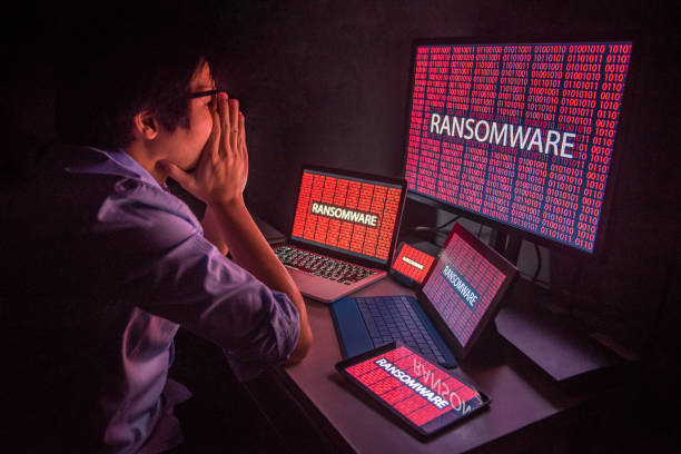 Young Asian male frustrated by ransomware cyber attack stock photo