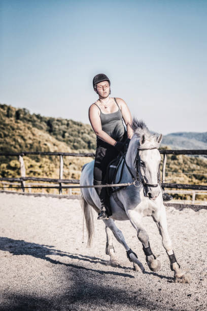 istock Horsewoman in a manege 803934416