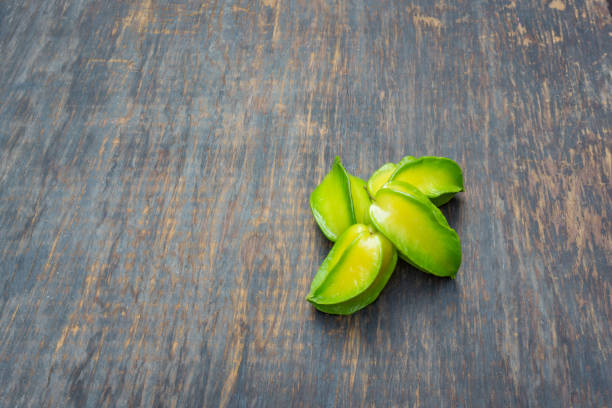 istock Group of starfruit isolated on wood background 803937700
