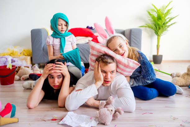 istock Tired parents and romping kids 803940204