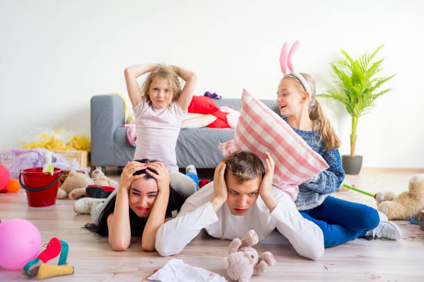 istock Tired parents and romping kids 803940342