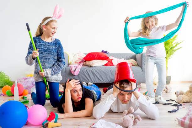 istock Tired parents and romping kids 803940430
