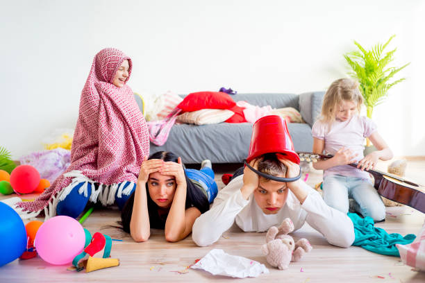 istock Tired parents and romping kids 803940542