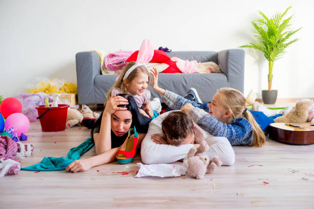 istock Tired parents and romping kids 803941022