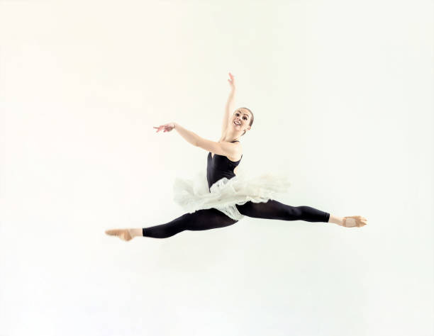 istock Elegant ballerina jump in ballet hall 803941048