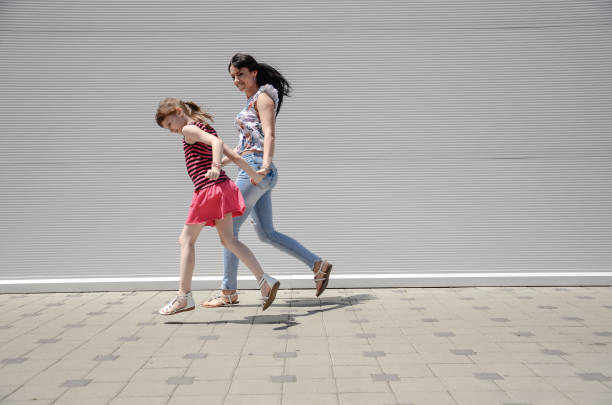 istock Mother and daughter running 803944096