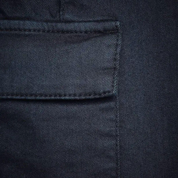 Navy blue denim textile for background closeup of pocket