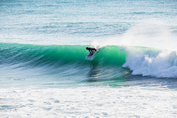istock Surfing on turquoise wave in ocean 803949754