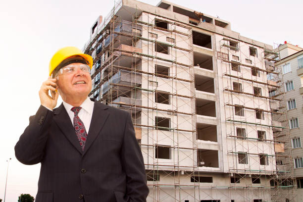 Senior construcion engineer talking on the phone and looks away