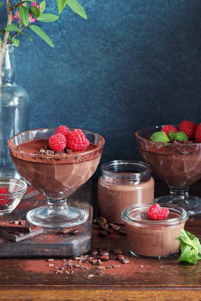 istock Chocolate dessert. Panna cotta, pudding or cream with fresh raspberries. 803952728