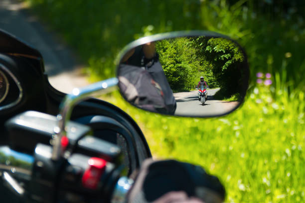 SPINDLERUV MLYN, CZECH REPUBLIC - 27.05.2017: Motorcycle on the rural road in mirror, Czech Republic