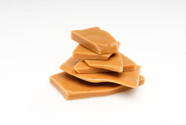 Stacked pieces of lightly salted caramel toffee isolated on white background