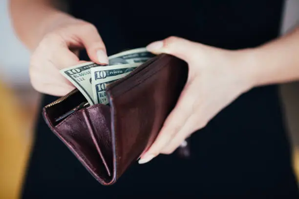 Photo of Woman is taking out money from wallet