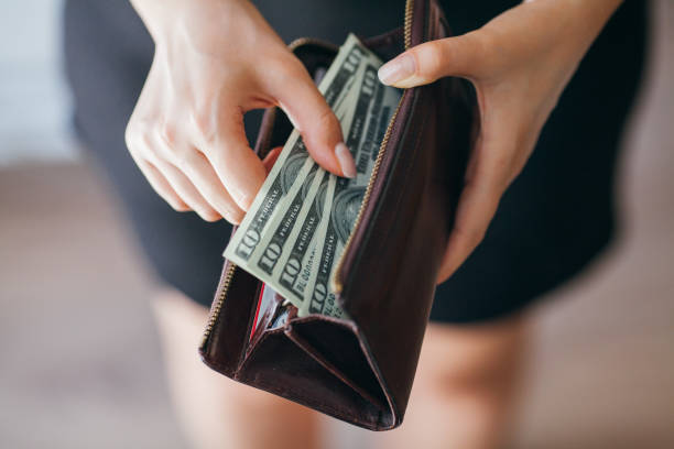 istock Woman is taking out money from wallet 803997970