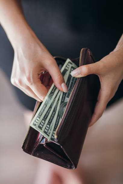 istock Woman is taking out money from wallet 803998212
