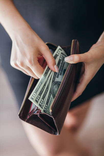 istock Woman is taking out money from wallet 803998218