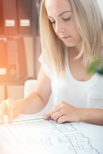 istock Female architect is showing her new project 803998236