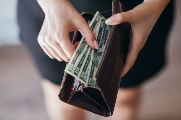 istock Woman is taking out money from wallet 804000568