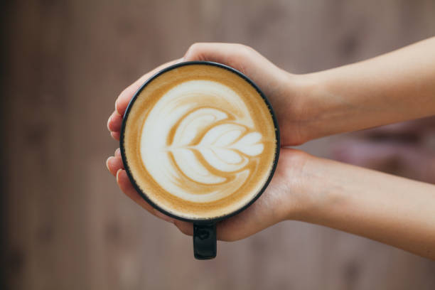 istock Lady's hands holding cup with latte art 804004762