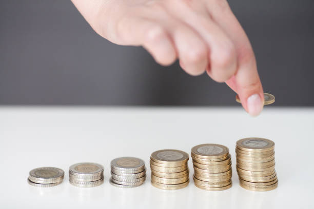 istock Woman put coins to stack of coins 804005262