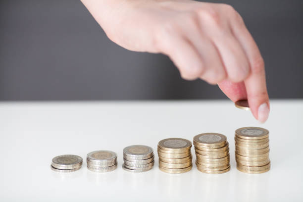 istock Woman put coins to stack of coins 804005336