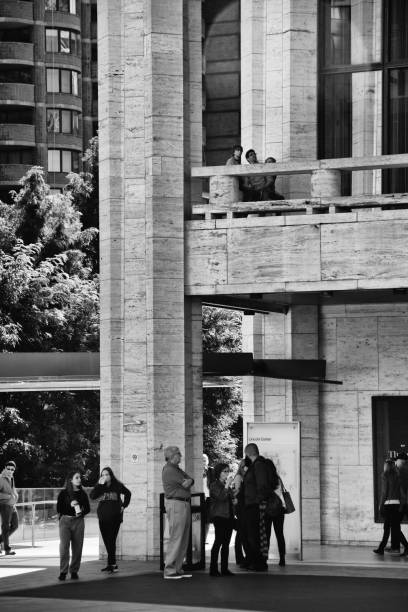 Urban Cultural Life, New York City, USA. People waiting outside Lincoln Center, Upper West Side, Manhattan. New York City, USA - October 15, 2016: People are seen waiting for an afternoon matinee music or arts performances at Lincoln Center, Upper West Side of Manhattan. columbus avenue stock pictures, royalty-free photos & images