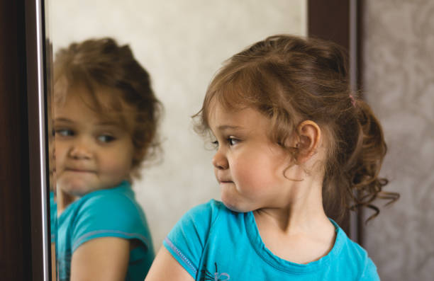 istock Little girl in front of a mirror 804010754
