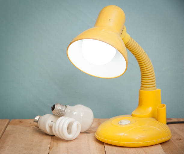 istock Table lamp on wooden background,vintage color toned image 804011044