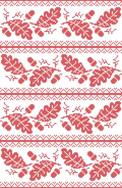 Scandinavian and Norwegian folk inspired festive autumn seamless pattern in cross stitch with acorn, oak leaf and  ornaments in red and white Scandinavian and Norwegian folk inspired festive autumn seamless pattern in cross stitch with acorn, oak leaf and  ornaments in red and white stitched image stock illustrations