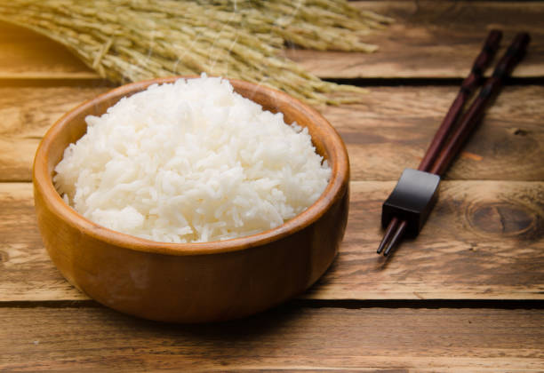 istock Cooked rice and paddy rice on wood 804022276