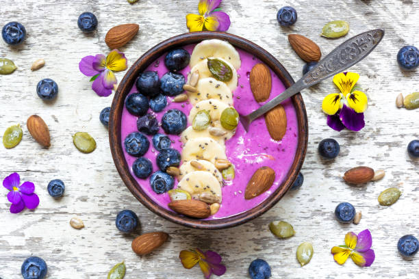 istock Smoothie bowl with fresh berries, nuts, seeds and spoon 804025860