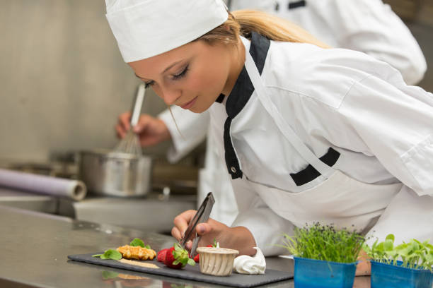 istock Chef decorating gourmet dessert in commercial kitchen 804030228
