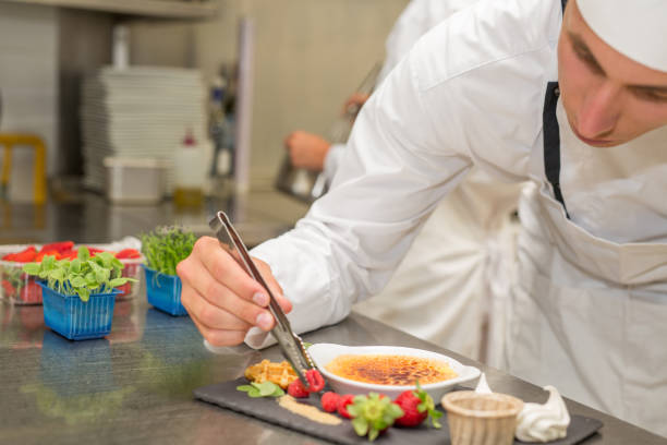istock Male chef preparing creme brulee and gourmet set 804030384